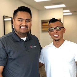 John Khut - John Khut (right) with a customer after cutting his hair (left).