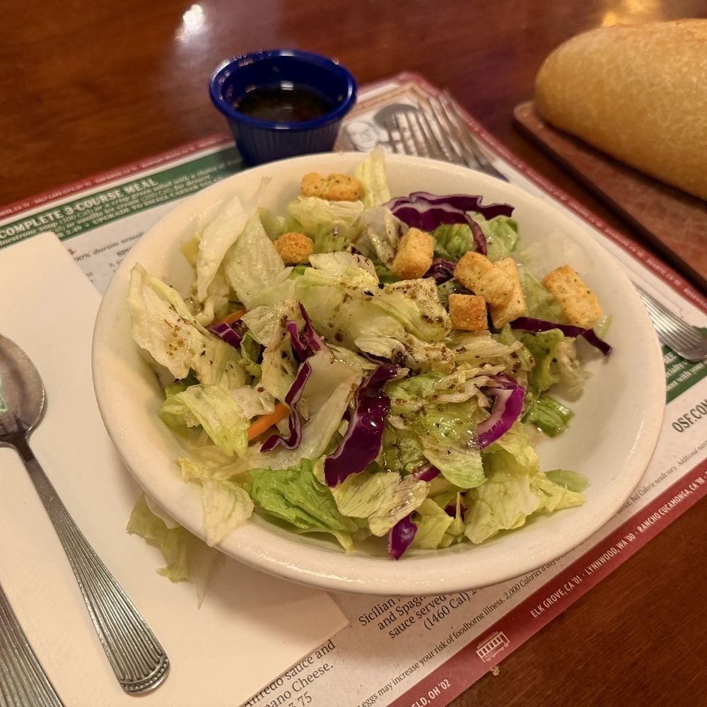 The Old Spaghetti Factory - Salad with Italian dressing and fresh sourdough bread. - Italian Near Me - Duarte, California The Old Spaghetti Factory - Salad with Italian dressing and fresh sourdough bread. - Italian Near Me - Duarte, California