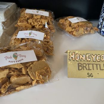 Pink Pony Soft Serve - You need these in your life. Think roasted caramel flavor and tender brittle consistency. - Several clear plastic bags of honeycomb brittle are displayed on a table, with a handwritten sign indicating the price and flavor. - Ice Cream & Frozen Yogurt Near Me - Albuquerque, New Mexico