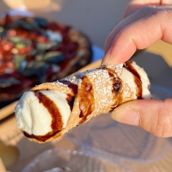 Josie’s Pizza Bar - a hand holding a pastry - Pizza Near Me - Glen Cove, New York Josie’s Pizza Bar - a hand holding a pastry - Pizza Near Me - Glen Cove, New York