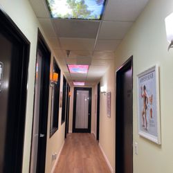 Massage Yini - A professional and welcoming entryway to our wellness center, featuring unique ceiling lighting designed to promote relaxation from the mome