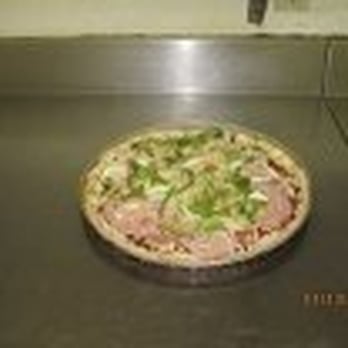 Dino's - a pizza in a pan on a counter - Pizza Near Me - Red Deer, Alberta Dino's - a pizza in a pan on a counter - Pizza Near Me - Red Deer, Alberta