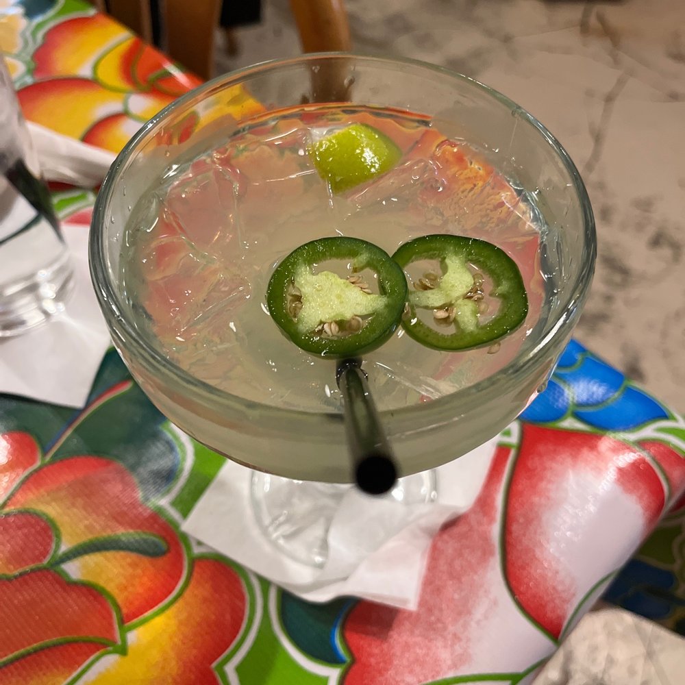 Maximo's Cantina - a glass with a drink and two slices of jalapenos - Mexican Near Me - Elkhorn, Nebraska Maximo's Cantina - a glass with a drink and two slices of jalapenos - Mexican Near Me - Elkhorn, Nebraska