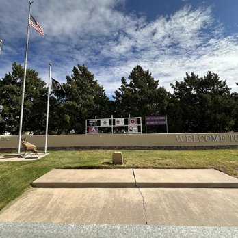 Clovis Veterans Park - 10.12.2025 - The image shows the entrance to Veterans Park in Clovis, NM, with a sign reading 'Welcome to Clovis' and flags flying, including the American flag. - Parks Near Me - Clovis, New Mexico