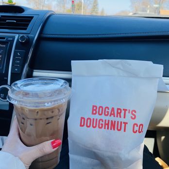 Northbound Supply - a person holding a cup of coffee and a bag of doughnuts - Coffee & Tea Near Me - Eau Claire, Wisconsin