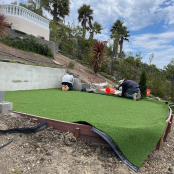Daniel Martinez Landscaping - a man working on a putting green - Landscaping Near Me