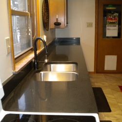Kwik Kitchens - durable quartz countertop complements new floor and cupboards