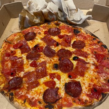 Timber Pizza - It is true, this pizza is greasy as you can see with the greased up napkins - Pizza Near Me - Arlington, Virginia