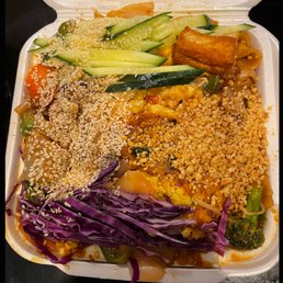 a variety of food in a styrofoam container a variety of food in a styrofoam container