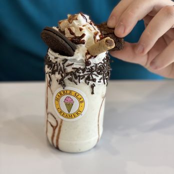 Marble Slab Creamery - a person taking a bite out of it - Ice Cream & Frozen Yogurt Near Me - Pooler, Georgia