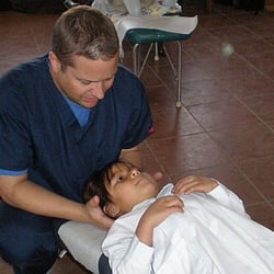 Hans C Delfo, DC - Treating patients in Bolivia.