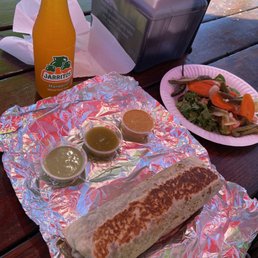 Asada supreme burrito with three of the four salsas Asada supreme burrito with three of the four salsas