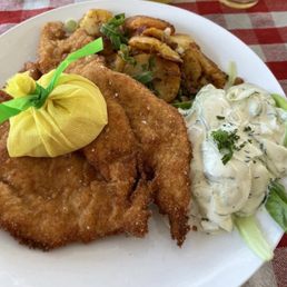 Schnitzel was so good cucumber salad and fried potatoes Schnitzel was so good cucumber salad and fried potatoes