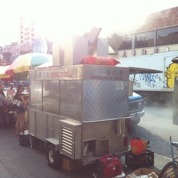 Xinjiang BBQ Cart - Smoke wafting from the BBQ cart. - Barbeque Near Me - Flushing, New York
