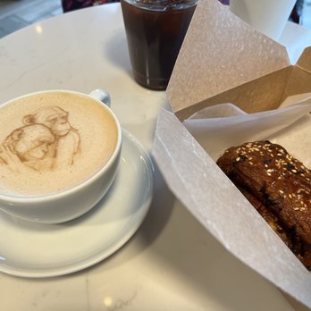 Grinder’s Coffee Bar - Latte with foam art and brisket croissant. - Coffee & Tea Near Me - Houston, Texas Grinder’s Coffee Bar - Latte with foam art and brisket croissant. - Coffee & Tea Near Me - Houston, Texas