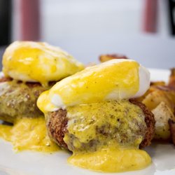 Bistro 36 - Eggs Jenny. Poached eggs over crab cakes with Hollandaise sauce and home fries.