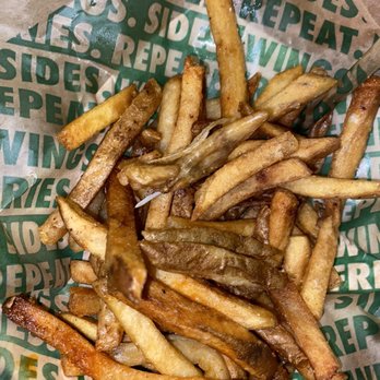 Wingstop - a basket of french fries on a table - Chicken Wings Near Me - Victorville, California