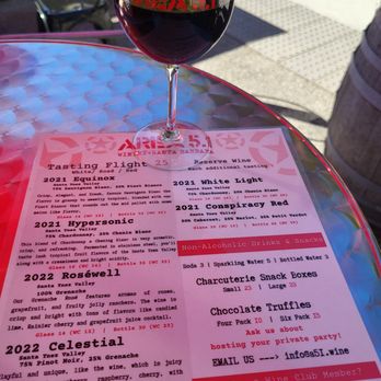 Orgullo Wine - The menu.  Pictured is a glass of The Conspiracy Red, which was my favorite wine here.  12/01/2023 - Wine Tasting Room Near Me - Santa Barbara, California