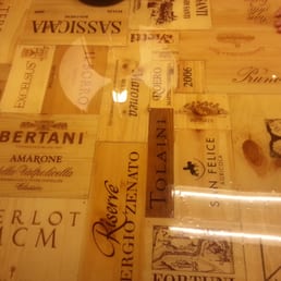 one of the tables made out of wine boxes with a glass on top