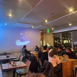 Dumpling Time - Inside w large screen playing K POP music