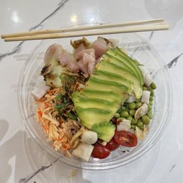 a bowl of food with chopsticks