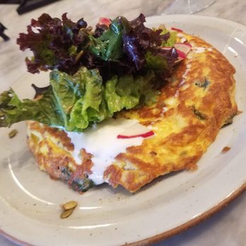 The Baker’s Table - Frittata with a half a salad over top, and creme fraiche. Good choice! - New American Near Me - Newport, Kentucky