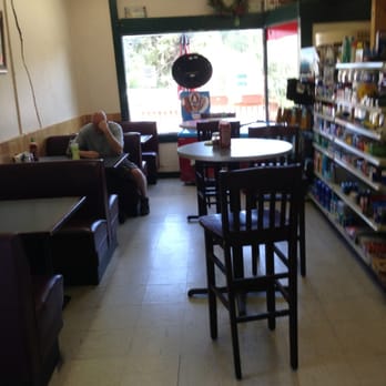 Larkspur Corner Market - a man sitting at a table - Grocery Near Me - Larkspur, Colorado