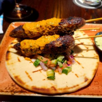 Puttshack - Oakbrook - Mediterranean Lamb Skewers - seven-spiced lamb, cucumber salsa, grilled pita, minted yogurt, peri-peri sauce - Mini Golf Near Me - Oak Brook, Illinois