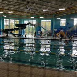 YMCA Community Center - Lap pool, big slide on left with 4 ft pool, and kiddie pool on right with water mini slide.