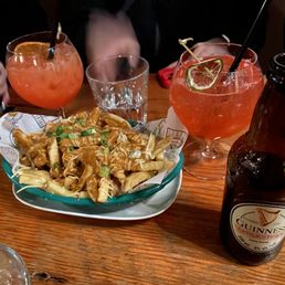 a plate of fries and a bottle of beer