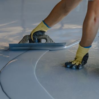 Red Fox Epoxy - a man using a trowet - Flooring Near Me Red Fox Epoxy - a man using a trowet - Flooring Near Me