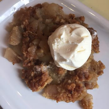 Bennetts - Apple crumble tipped out of bowl to cool with ice cream - Modern European Near Me - Belfast, BFS