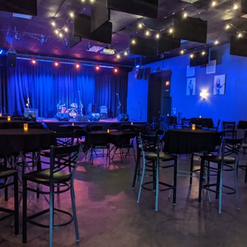 Cult Classic Brewing - tables and chairs in a dimly lit room - Breweries Near Me - Stevensville, Maryland