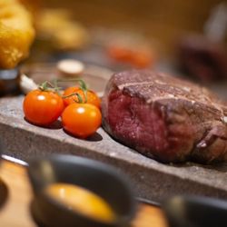 The Forge Black Rock Steakhouse - 8oz bistro rump steak served on the stone with cherry tomatoes on the black rock grill in Derby Blacksmith's yard Sadlergate