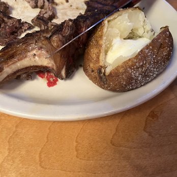 Texas Roadhouse - Remnants of 20 ounce bone in ribeye entree - Steakhouses Near Me - Durham, North Carolina