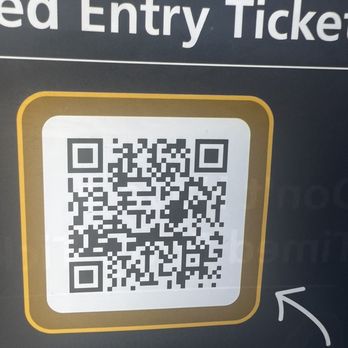 Moab Information Center - A QR code is displayed on a sign at Moab Information Center, Utah, for visitors to scan for timed entry reservations, with partial text visible. - Visitor Centers Near Me - Moab, Utah