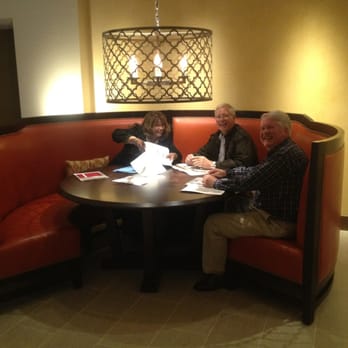 C3 Restaurant - a group of people sitting around a table - New American Near Me - Riverside, California
