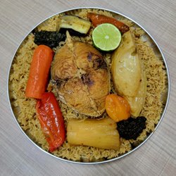 African Haitian Cuisine - Long-grain rice with tomatoes, onions, spices, vegetables, and meat, cooked together for a sweet and savory taste.