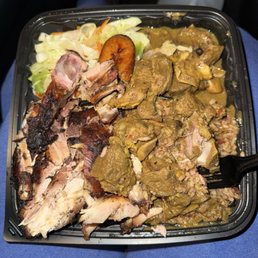 Combo jerk chicken and curry goat (missing festival bread and only one plantain...)