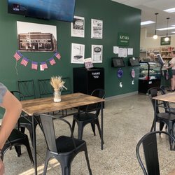 Flour Donuts And Bakery - Inside has places to sit and eat. There is a separate deli counter to order sandwiches and bread at