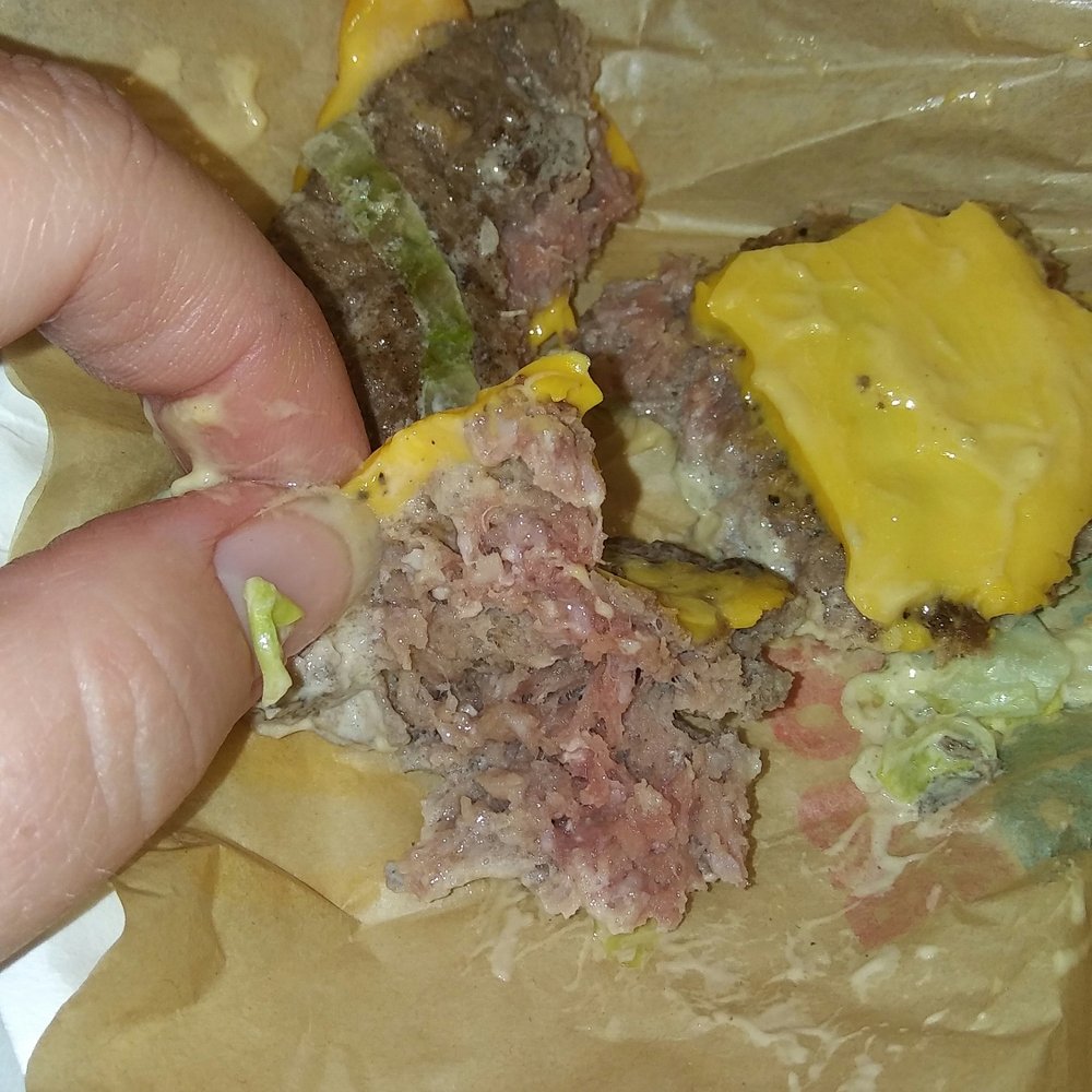 McDonald's - a hand holding a hamburger - Fast Food Near Me - Brandon, Florida