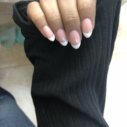 Acrylic almond shape nails with French tip.