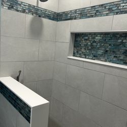 Floor & Decor - Glass mosaic tiles used as a border and in the niche