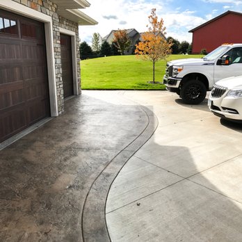 Kali Concrete - Broom finished concrete driveway with textured and stained garage front. - Masonry/Concrete Near Me - Belle Plaine, Minnesota Kali Concrete - Broom finished concrete driveway with textured and stained garage front. - Masonry/Concrete Near Me - Belle Plaine, Minnesota