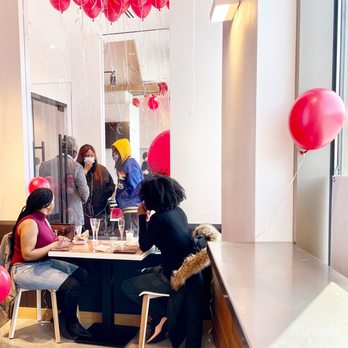 Roaming Rooster - a group of people sitting at a table - Halal Near Me - Washington, DC, District of Columbia