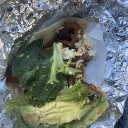 Chicken taco with a big bite taken out of it. Chicken taco with a big bite taken out of it.