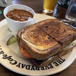 Brisket sandwich on homemade bread with house made baked beans side. Brisket sandwich on homemade bread with house made baked beans side.