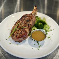 Double boned pork chop served with broccoli and an apple bourbon glaze
