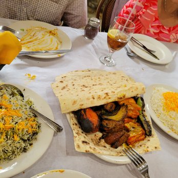 Raffi's Place - The bread is hiding a beautiful platter of chicken and beef kababs and grilled tomatoes, onion and peppers. - Middle Eastern Near Me - Glendale, California Raffi's Place - The bread is hiding a beautiful platter of chicken and beef kababs and grilled tomatoes, onion and peppers. - Middle Eastern Near Me - Glendale, California