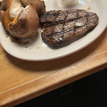 Texas Roadhouse - Very well done steak and sweet potato with honey cinnamon butter and brown sugar - Steakhouses Near Me - Joplin, Missouri